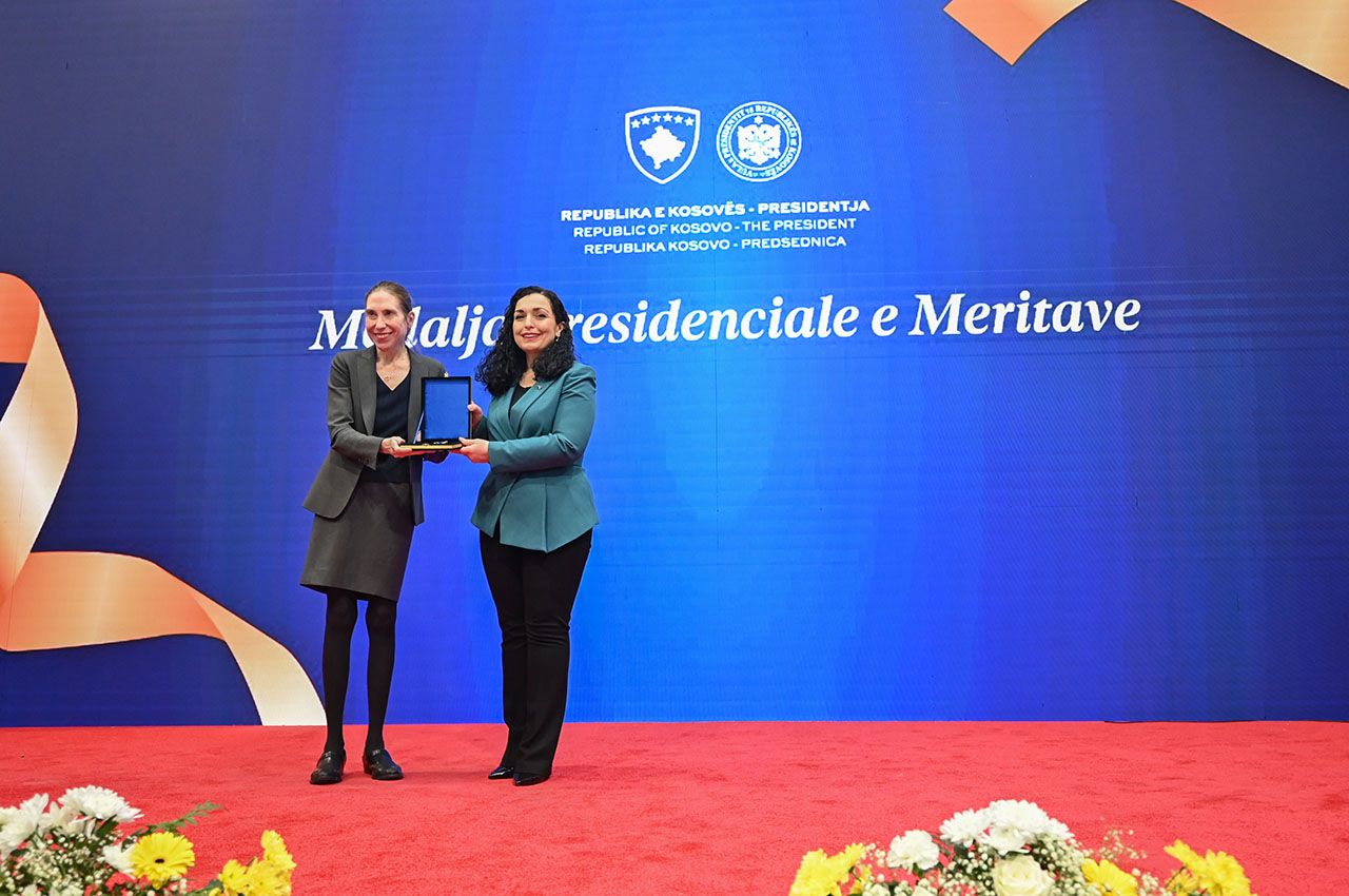 Chicago-Kent Dean Anita Krug accepts the Presidential Medal of Merits from Kosovo President Vjosa Osmani Sadriu